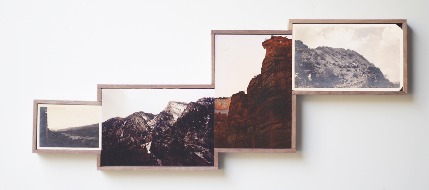 Picture of four framed vintage landscape photos on the wall.