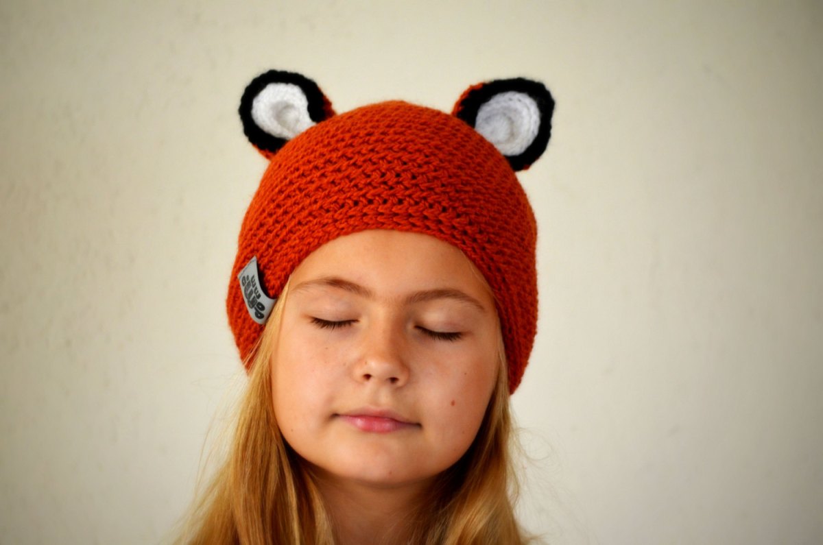 Baby girl portrait wearing a cute fox hat.