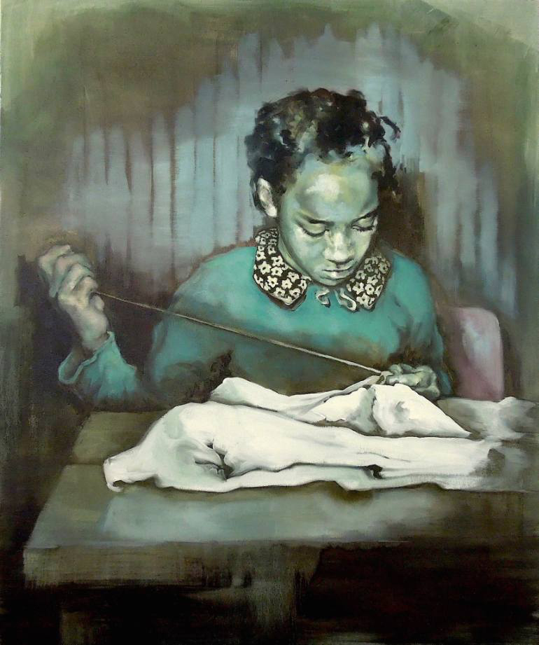 Portrait of a young girl hand sewing on a table.