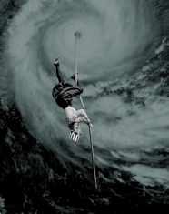Collage of an upside down woman on a rope that is coming down from a giant sky spiral.