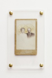 Still life photo of a framed vintage portrait sewed with a golden thread.