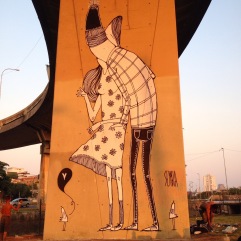 Photo of a bridge pole decorated with a giant illustration of a couple kissing.
