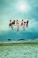 Group of baby girls holding hands and creating a circle, floating into the air.