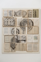 Vintage books installation with a doilies composition painted over.