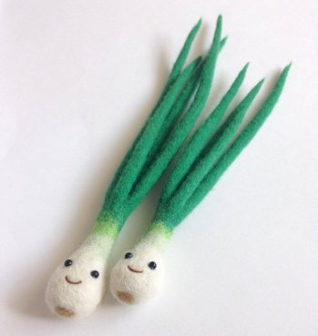 Still life of two spring onions made of felt.