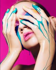 Female fashion shot with a colorful liquid dropping on her hands illustrated.