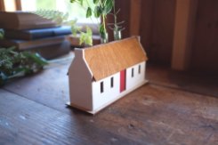Still life photo of a miniature mill house.