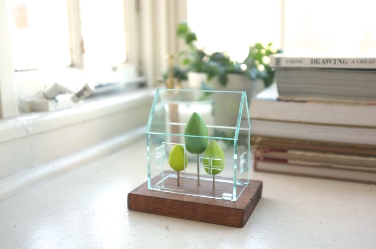 Still life of a miniature greenhouse structure.