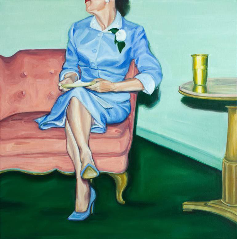 Elegant woman wearing a blue dress sit on a couch portrait.